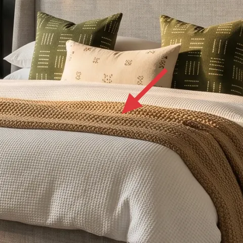 knit throw blanket (tan) on the bed