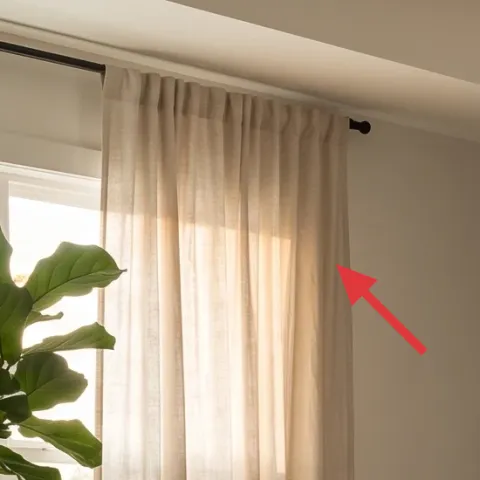 curtain panels (light beige/cream) across the window