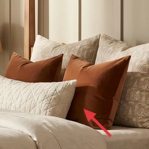 decorative throw pillows in cream, tan, and rust colors