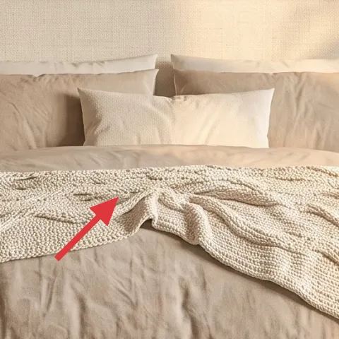 cream throw blanket over bed