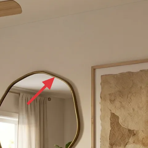 oval mirror with brass-toned frame